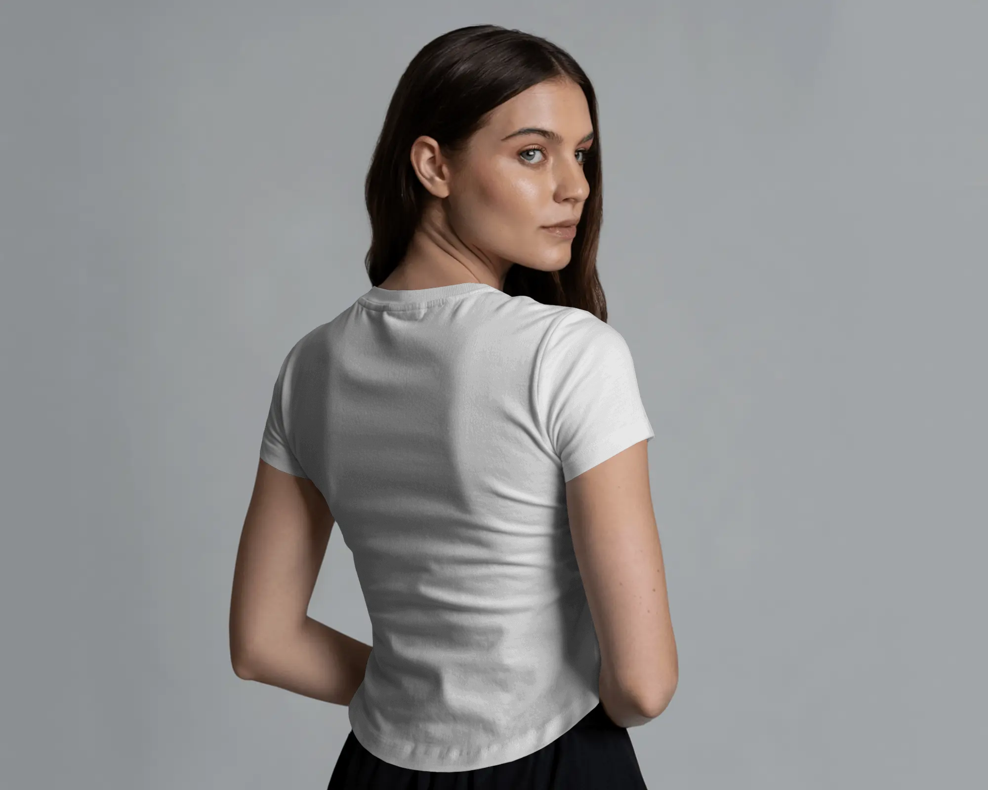 Woman wearing a white labubu t-shirt against a plain background