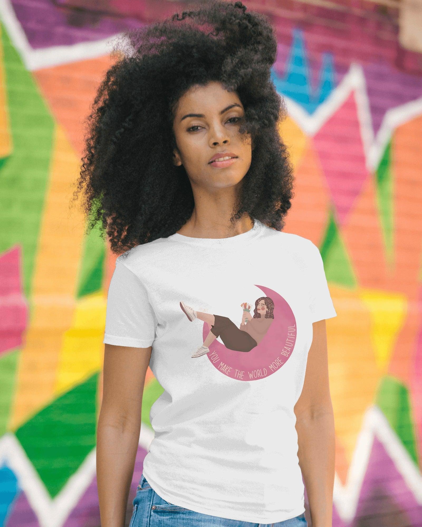 White women's t-shirt from Nitorious Atelier featuring the uplifting quote 'You Make the World More Beautiful' in a stylish print. Made from premium cotton for a soft, comfortable, and durable fit.