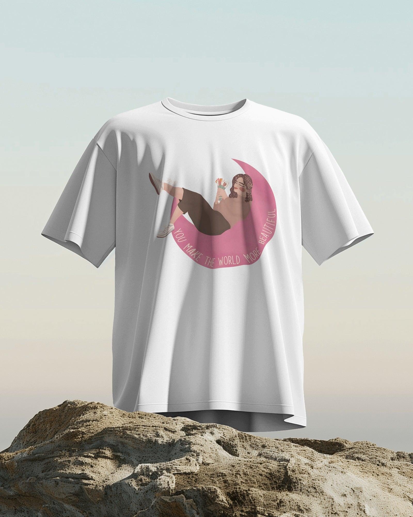 White women's t-shirt from Nitorious Atelier featuring the uplifting quote 'You Make the World More Beautiful' in a stylish print. Made from premium cotton for a soft, comfortable, and durable fit.