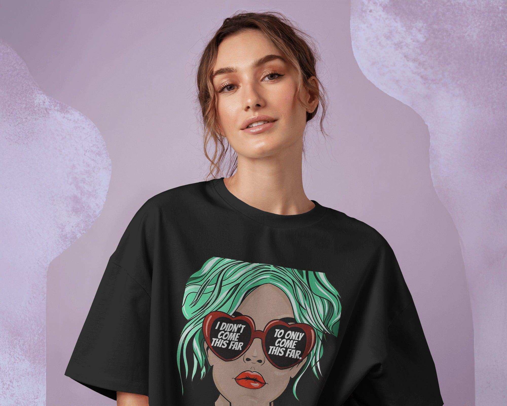 Oversized black t-shirt for women featuring the motivational quote "I Didn’t Come This Far to Only Come This Far" in bold typography. Made from premium cotton, this t-shirt offers a relaxed and comfortable fit. Worn by a confident girl, the statement design adds an empowering touch to casual and streetwear outfits.