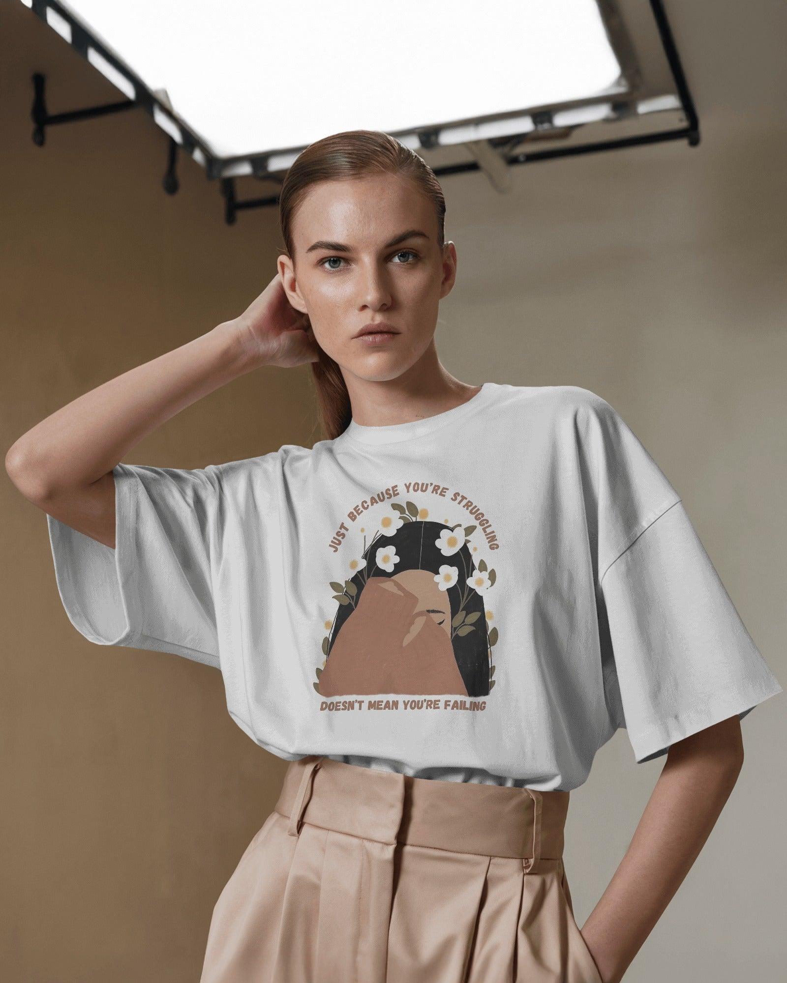 White oversized Tiara t-shirt for women from Nitorious Atelier. Made from premium cotton, this stylish and comfortable t-shirt features a minimal yet elegant tiara design, perfect for a casual yet chic look. Breathable fabric ensures all-day comfort, making it a must-have wardrobe essential.