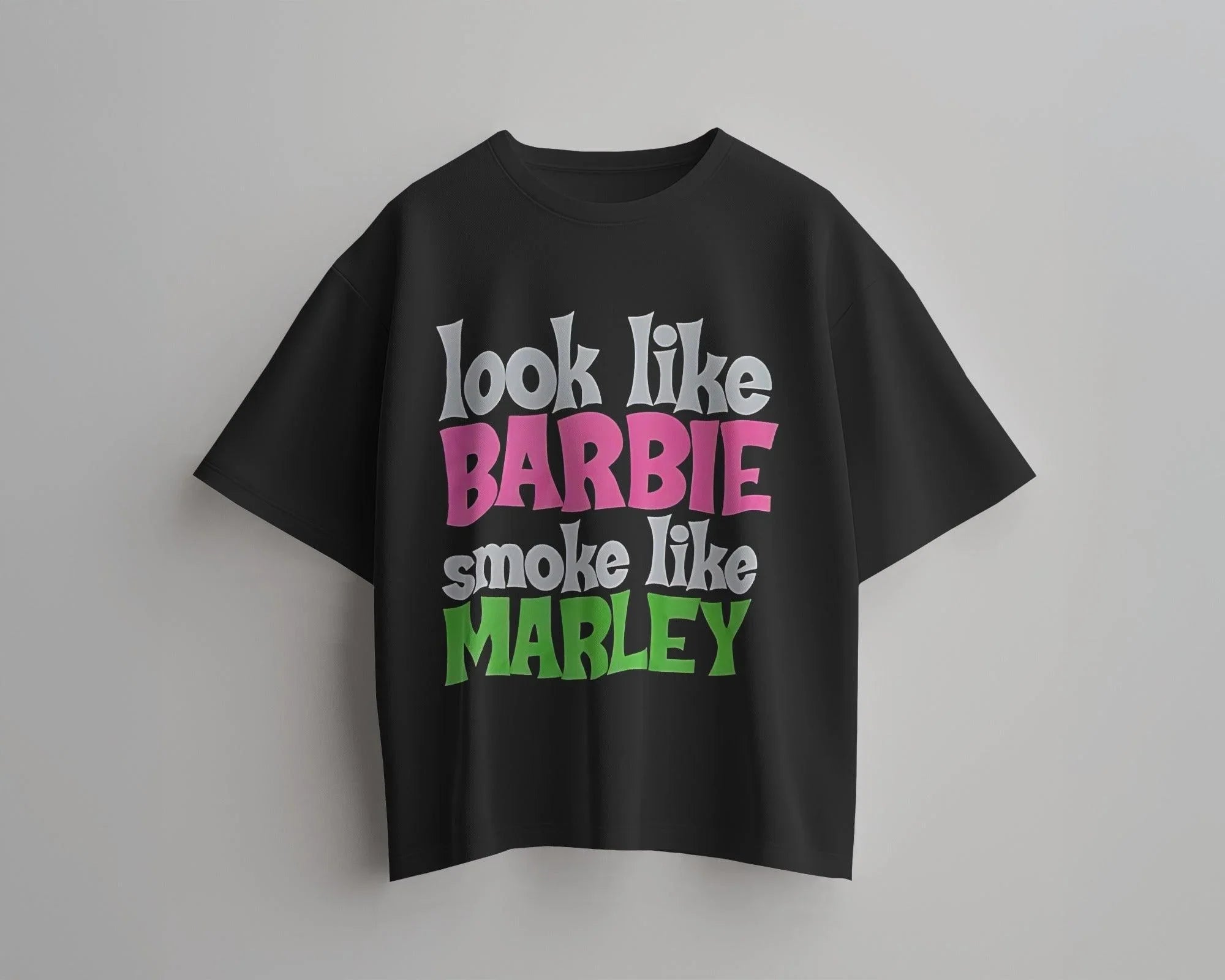 Black oversized t-shirt featuring a unique Barbie x Bob Marley graphic. This bold fusion of reggae vibes and pop culture creates a standout streetwear piece. Made from premium cotton for ultimate comfort and style.