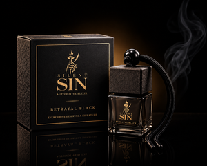 Silent Sin Betrayal Black automotive elixir perfume bottle with a black skull cap and black cord, displayed next to its textured black and gold packaging box on a reflective black surface.