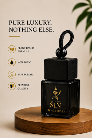 A black glass bottle of 'Silent  Sin' Black Hide New car leather fragrance oil with a black cap and loop, displayed on a wooden pedestal against a beige background with promotional text and leaf graphics. Silent Sin Automotive Elixir Car Fragrance