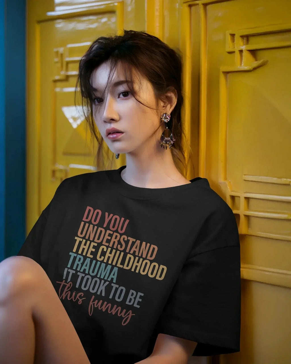 Oversized black t-shirt with bold white text that reads, ‘Do you understand the childhood trauma it took to be this funny?’ A witty and relatable statement piece, crafted from premium cotton for comfort and effortless streetwear style.