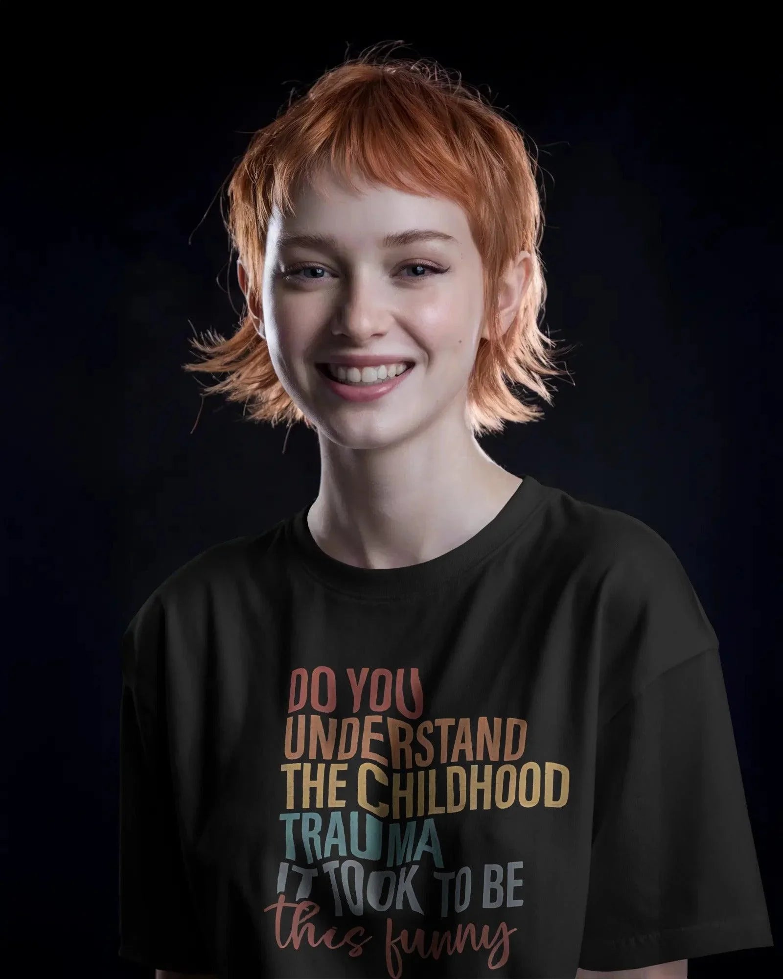 Oversized black t-shirt with bold white text that reads, ‘Do you understand the childhood trauma it took to be this funny?’ A witty and relatable statement piece, crafted from premium cotton for comfort and effortless streetwear style.