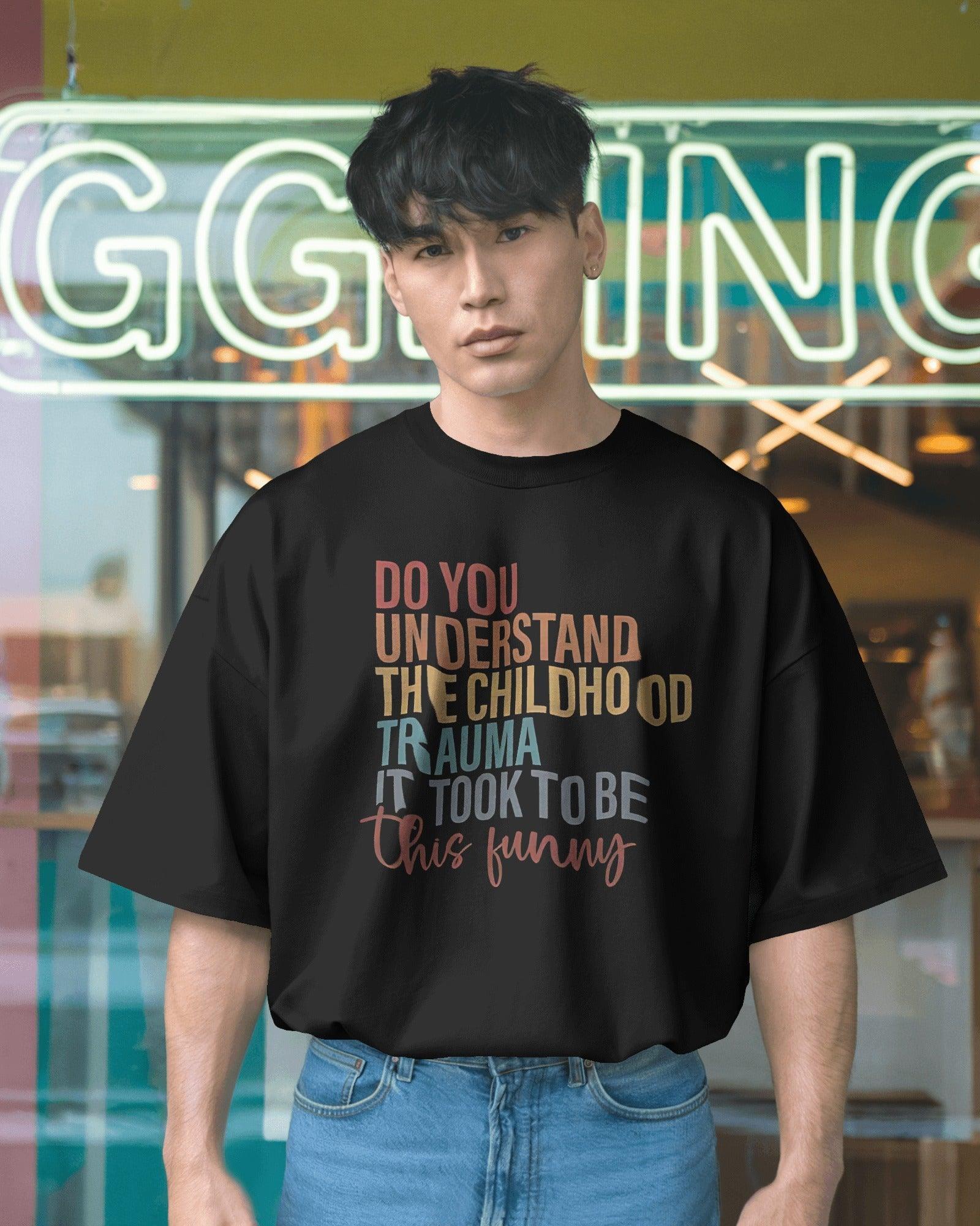 Oversized black t-shirt with bold white text that reads, ‘Do you understand the childhood trauma it took to be this funny?’ A witty and relatable statement piece, crafted from premium cotton for comfort and effortless streetwear style.