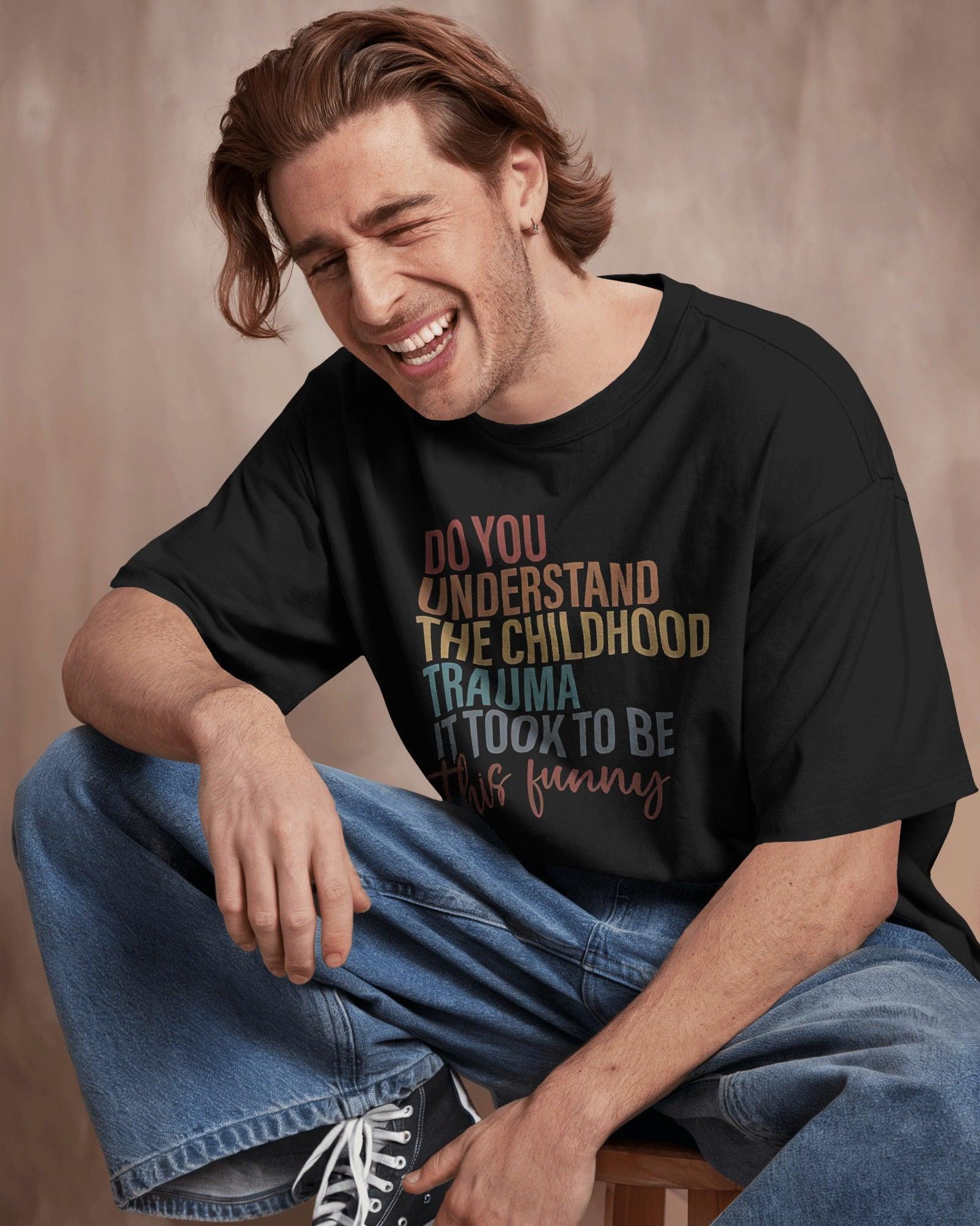 Oversized black t-shirt with bold white text that reads, ‘Do you understand the childhood trauma it took to be this funny?’ A witty and relatable statement piece, crafted from premium cotton for comfort and effortless streetwear style.