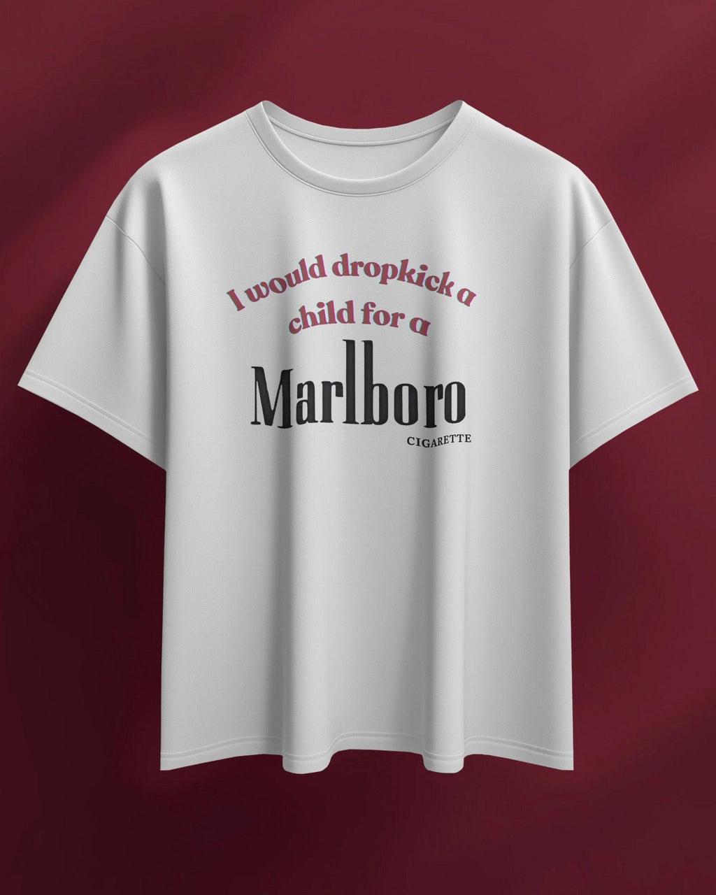 White oversized t-shirt featuring a bold, edgy text design. The statement 'I would dropkick a child for a Marlboro cigarette' is printed in a mix of red and black fonts, adding a rebellious streetwear vibe. Made from premium cotton, this t-shirt blends comfort with a striking, ironic aesthetic