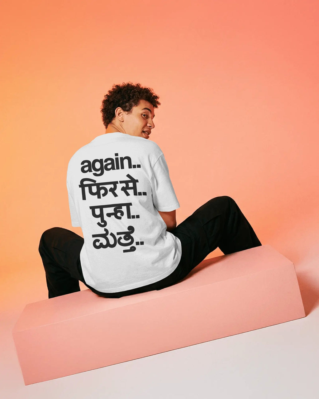 Fred Again oversized white tee with minimalist front print and multilingual design