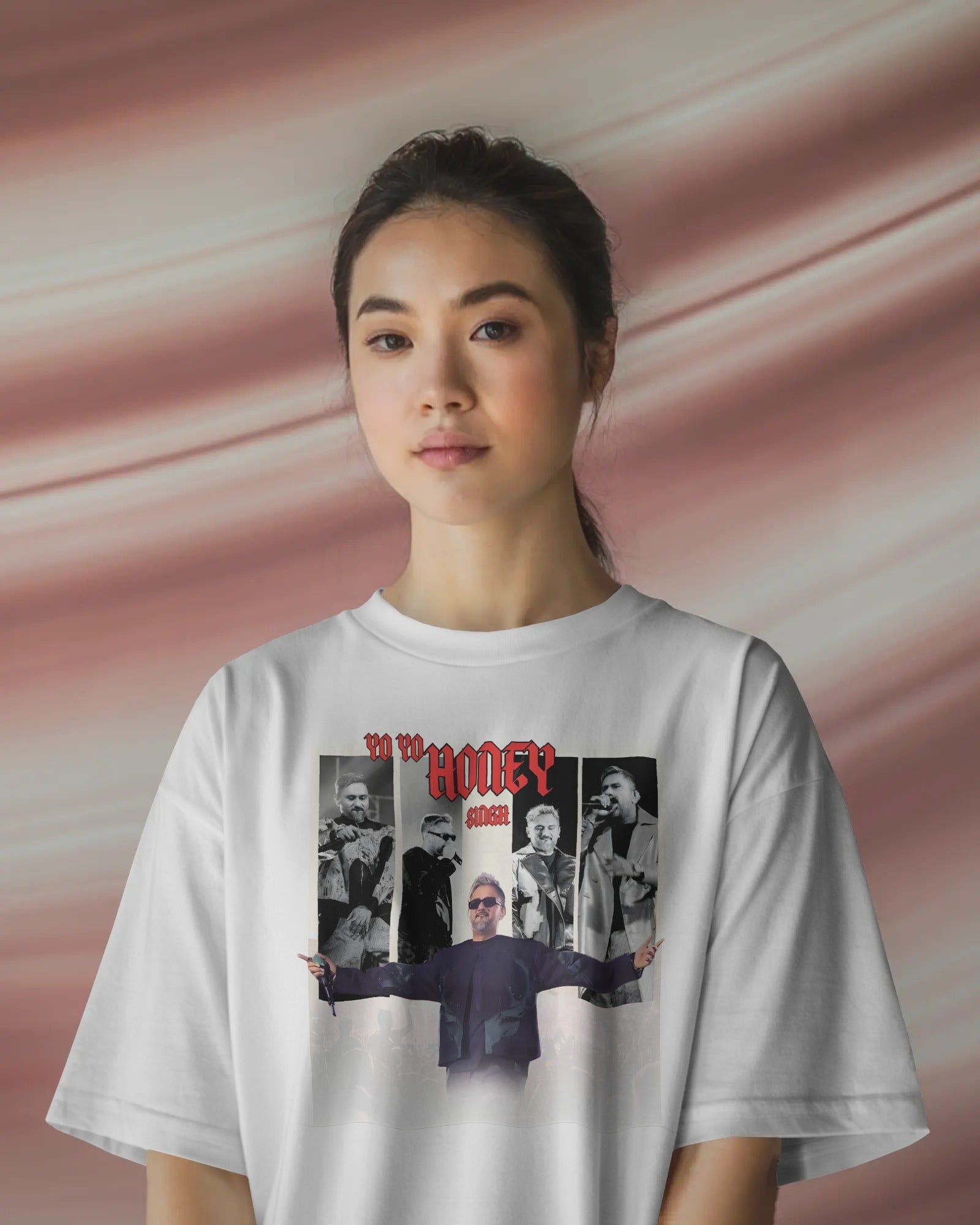 Person wearing a Honey Singh India concert white t-shirt with graphic design on a pink background