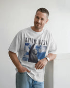 Man wearing a white t-shirt with a graphic design and text, standing against a plain background. Kanye West Ye Live Concert Tour 