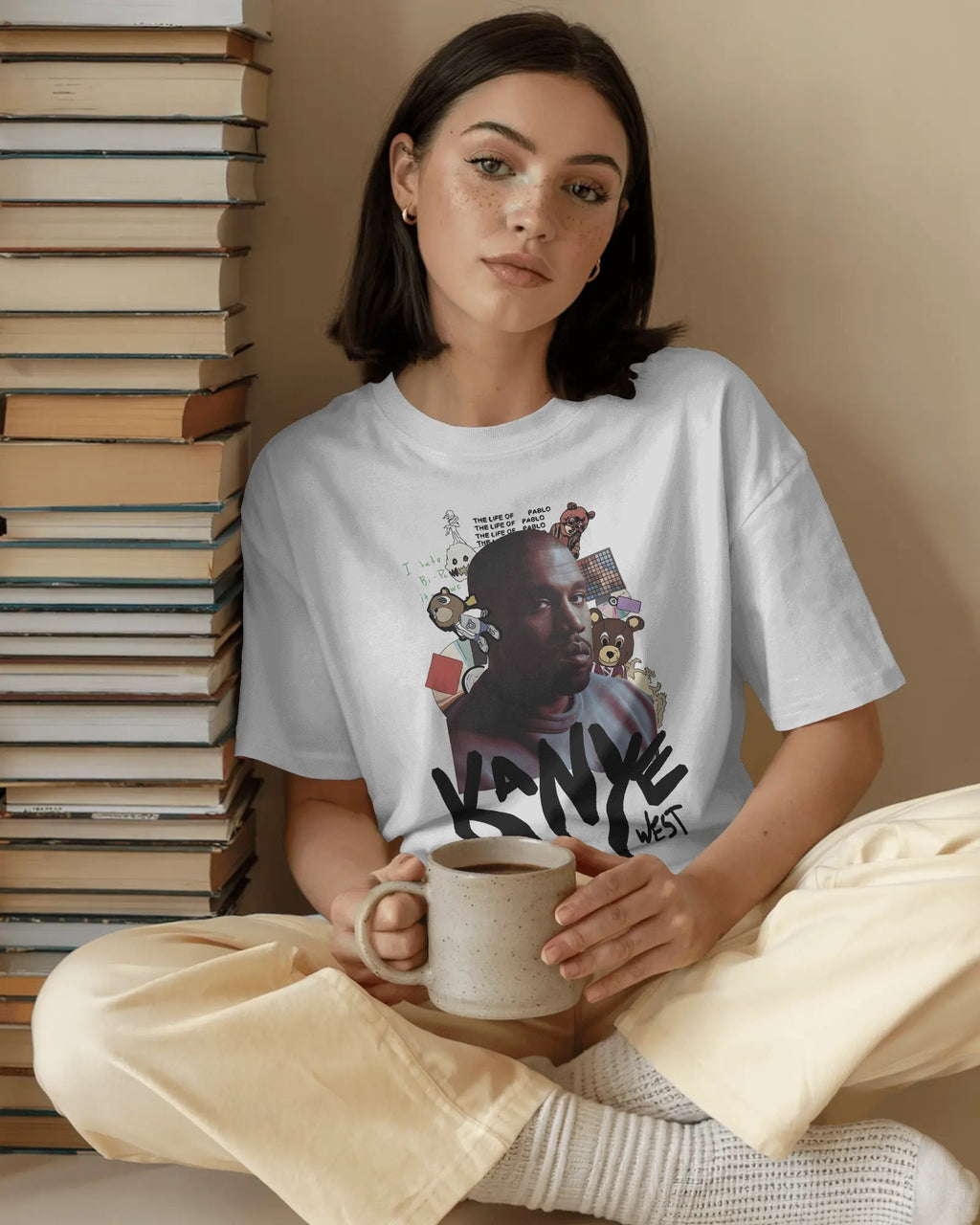 Oversized white graphic tee featuring Kanye West portrait and graffiti text