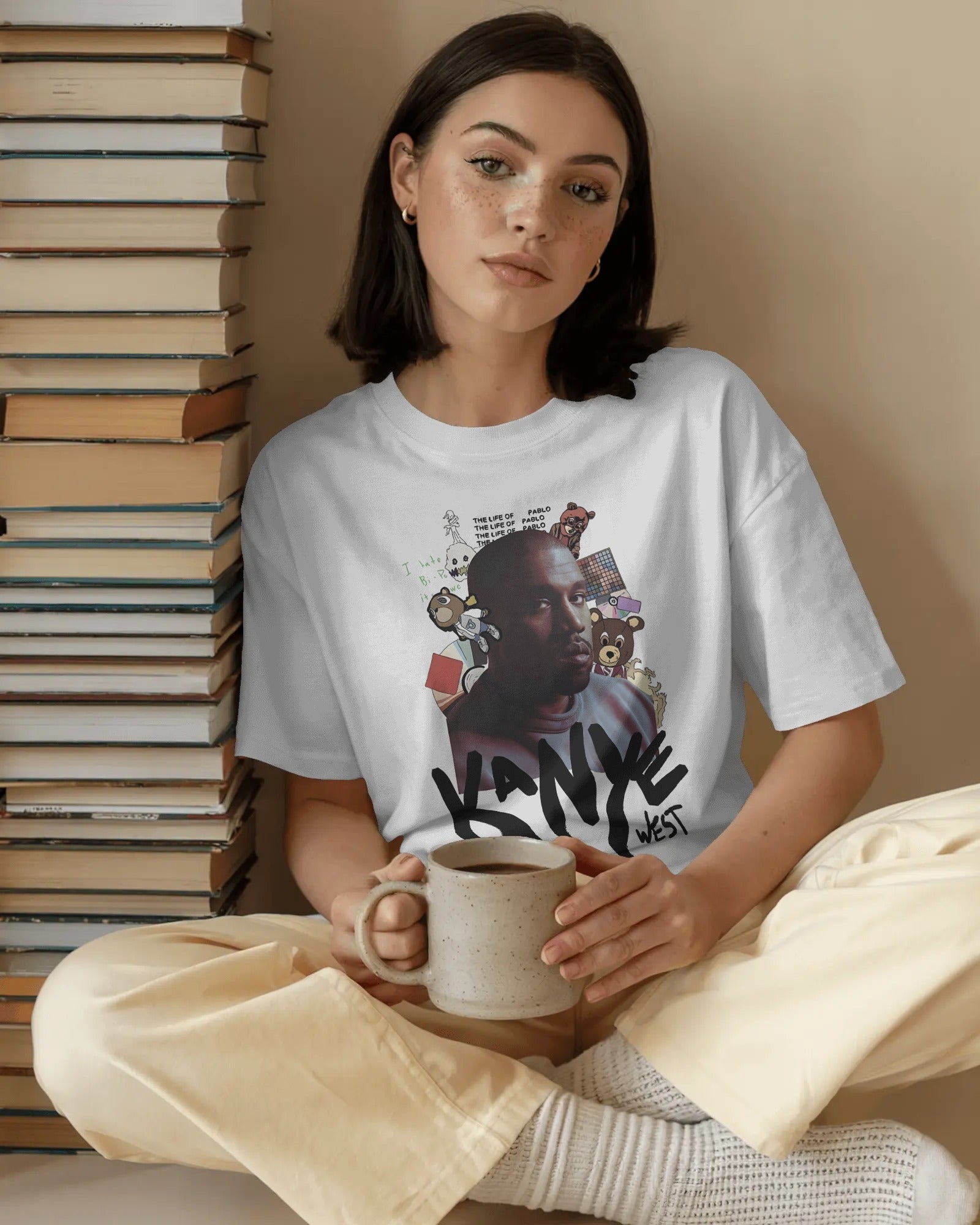 Oversized white graphic tee featuring Kanye West portrait and graffiti text