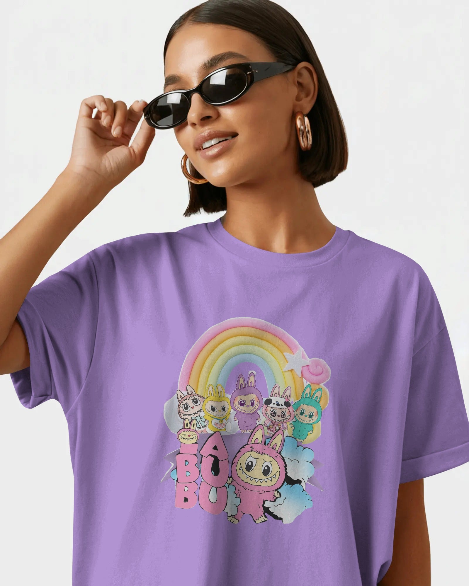 Person wearing a lavender Labubu t-shirt with cartoon characters and a rainbow design.