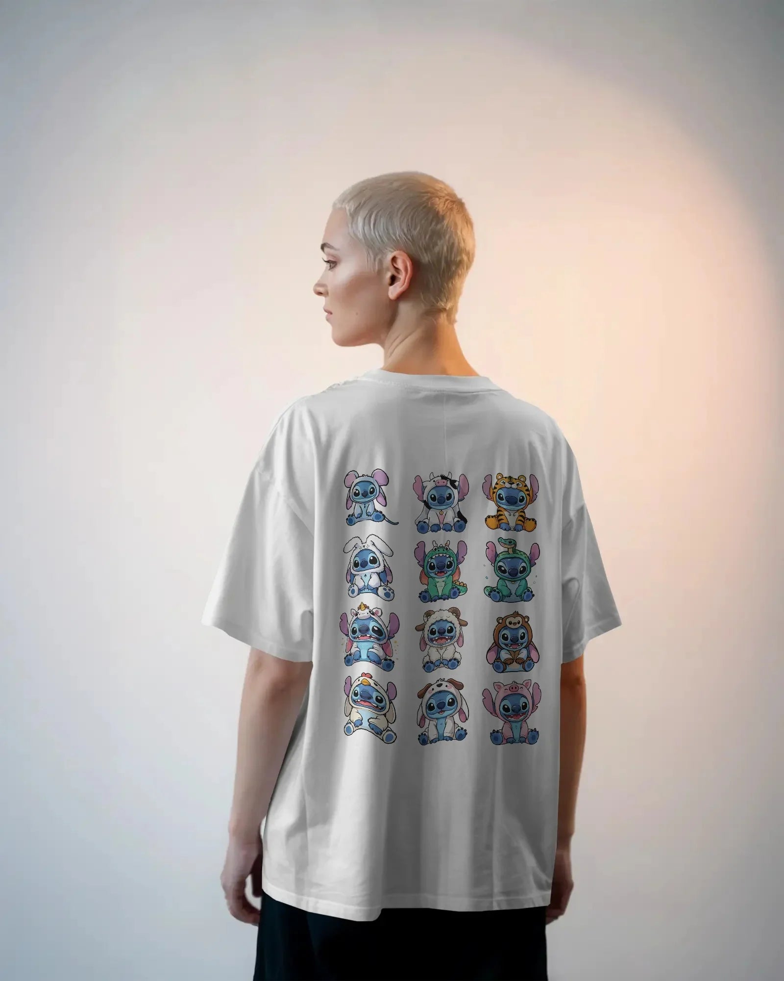 White oversized t-shirt from Nitorious Atelier featuring a striking ‘Lio and Stiches’ graphic print. Crafted from 220 GSM premium cotton for a soft, breathable, and durable streetwear look