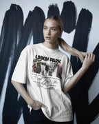 Linkin Park Signature Legacy Oversized White T-Shirt with album art collage and band signatures worn by model with futuristic sunglasses