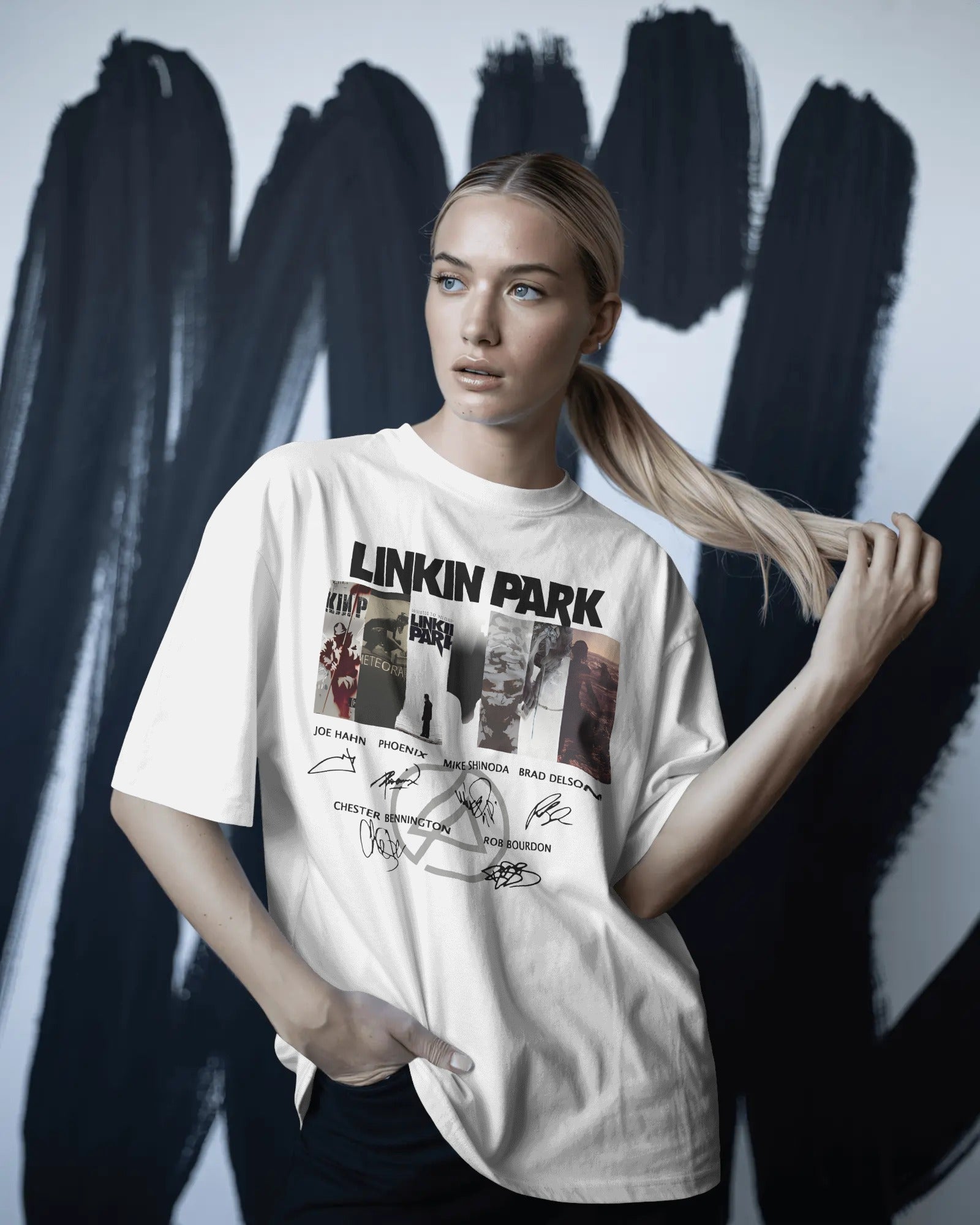 Linkin Park Signature Legacy Oversized White T-Shirt with album art collage and band signatures worn by model with futuristic sunglasses