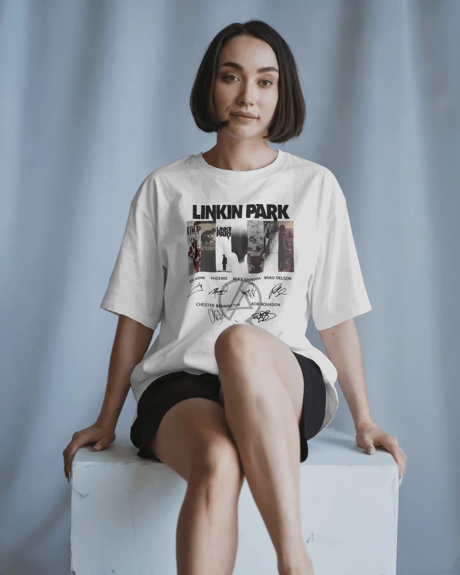 Linkin Park Signature Legacy Oversized White T-Shirt with album art collage and band signatures worn by model with futuristic sunglasses