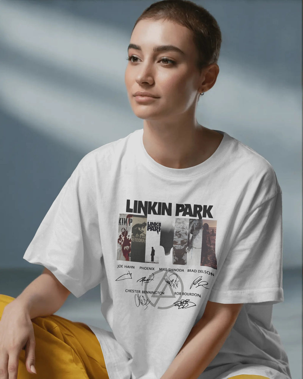 Linkin Park Signature Legacy Oversized White T-Shirt with album art collage and band signatures worn by model with futuristic sunglasses