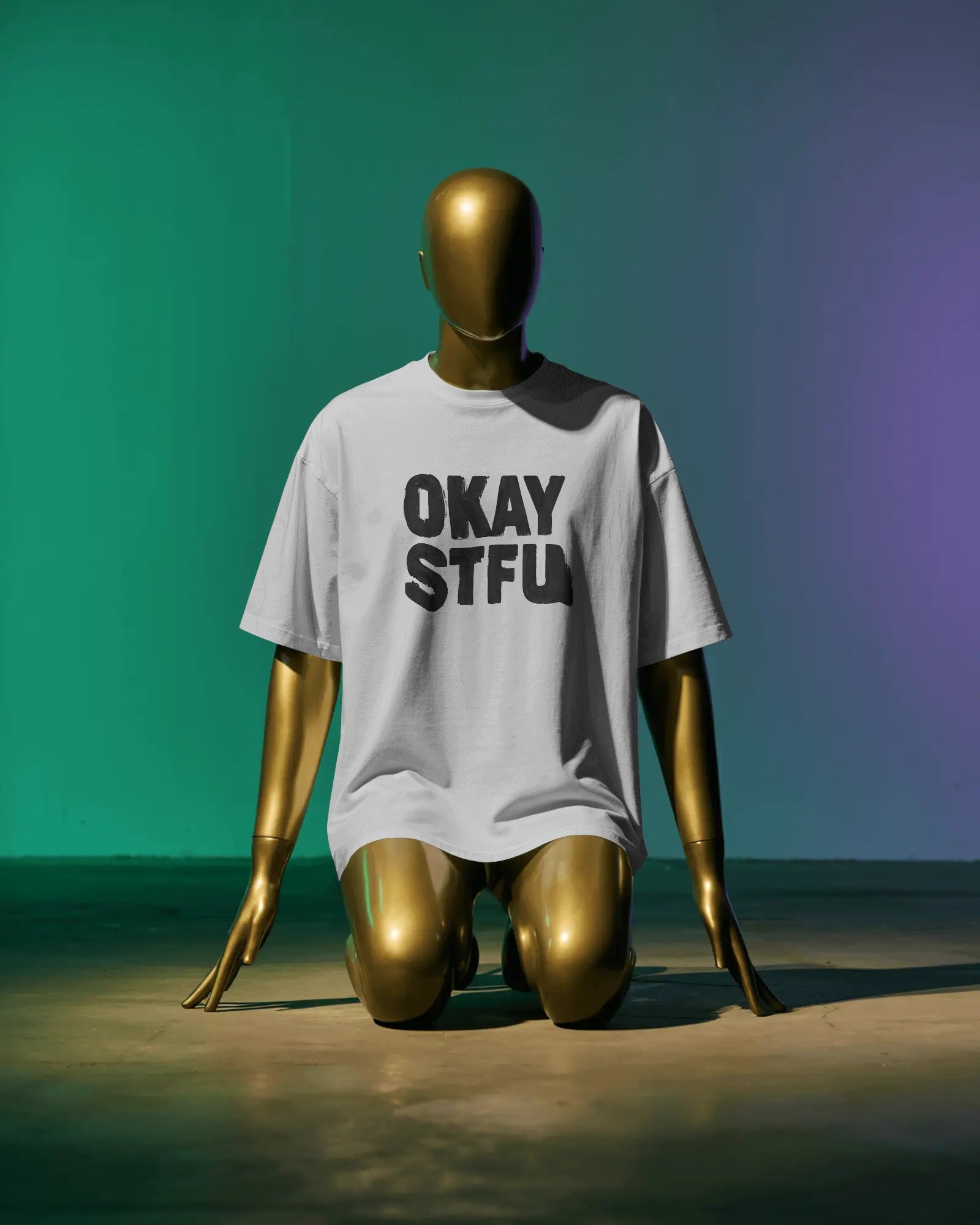 Person wearing a white Nitorious Atelier AP Dhillon concert t-shirt with 'OKAY STFU' text against a light background