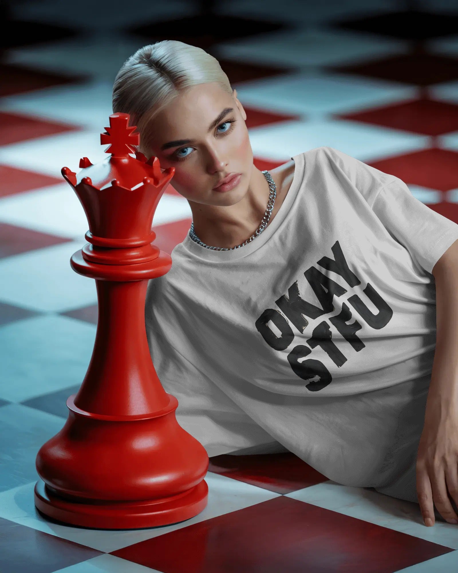 Person wearing a white Nitorious Atelier AP Dhillon concert t-shirt with 'OKAY STFU' text against a light background