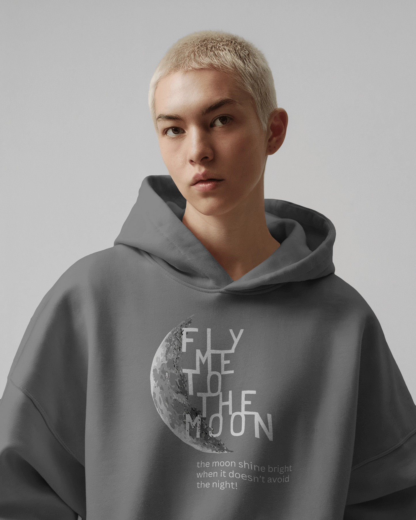 Grey 'Fly Me to the Moon' sweatshirt from Nitorious Atelier featuring a minimalist moon graphic and retro typography. Made with premium cotton fleece for comfort and warmth, perfect for cozy, stylish looks.