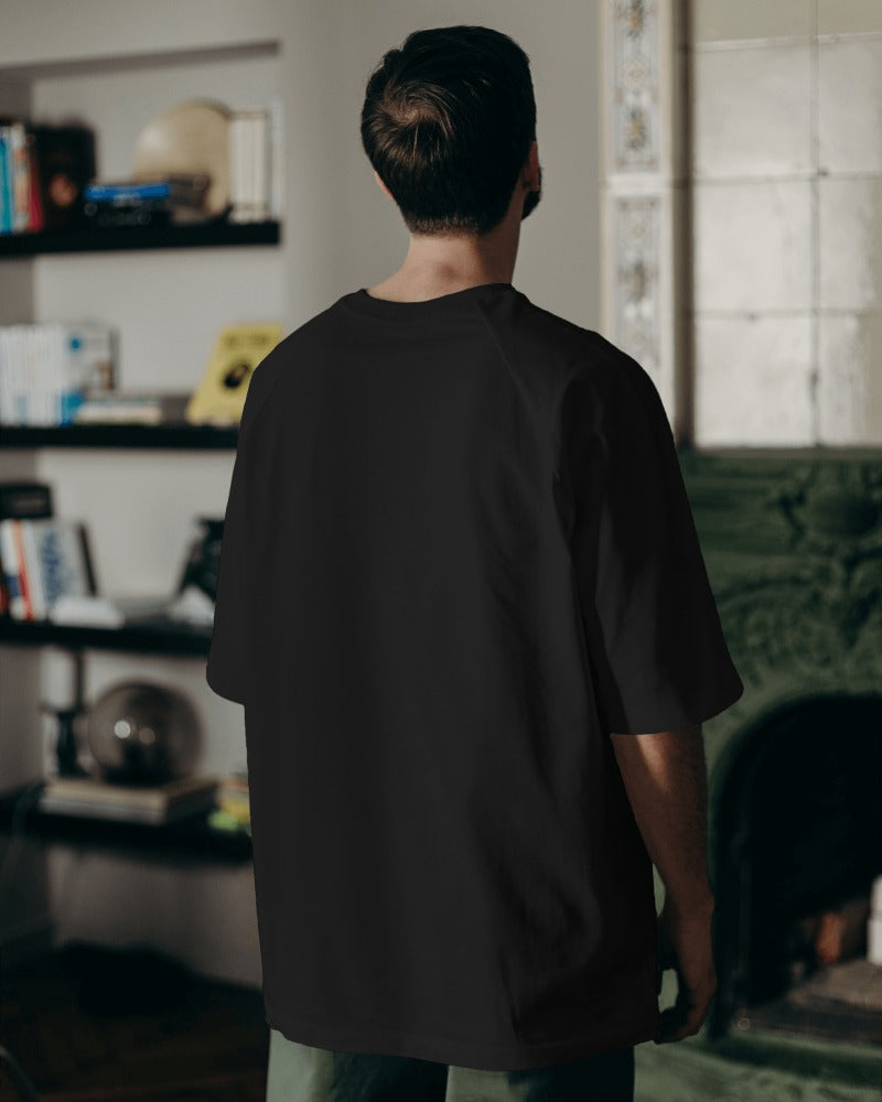 Oversized black t-shirt from Nitorious Atelier featuring the bold slogan 'Bad Boys Do Better.' Made from premium cotton, this t-shirt offers a stylish and comfortable fit.