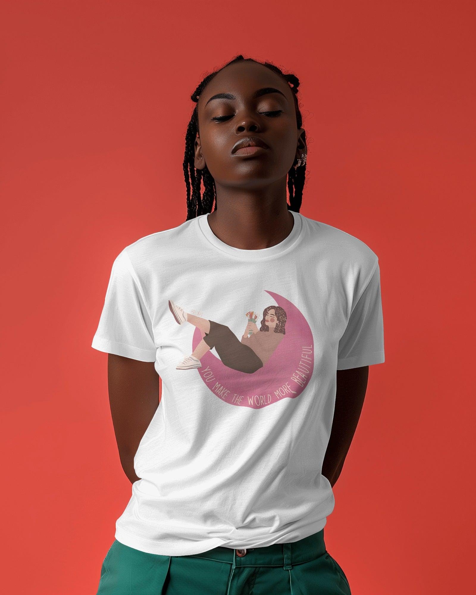 White women's t-shirt from Nitorious Atelier featuring the uplifting quote 'You Make the World More Beautiful' in a stylish print. Made from premium cotton for a soft, comfortable, and durable fit.