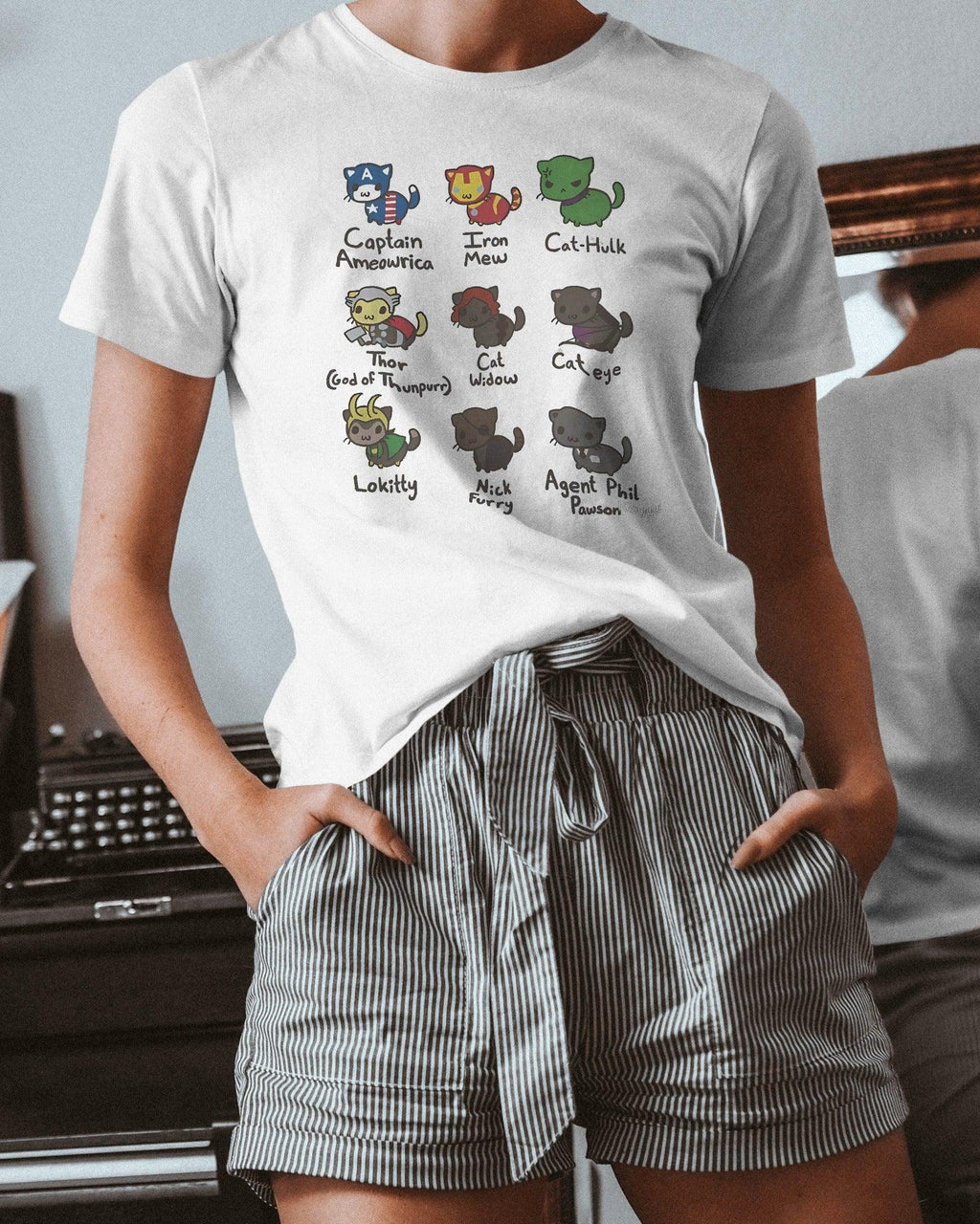 Rasha Thadani wearing the White Regular Fit Cat Avengers Assemble T-shirt from Nitorious Atelier. This premium cotton tee showcases a playful crossover design of cats as iconic superheroes, offering both style and comfort.