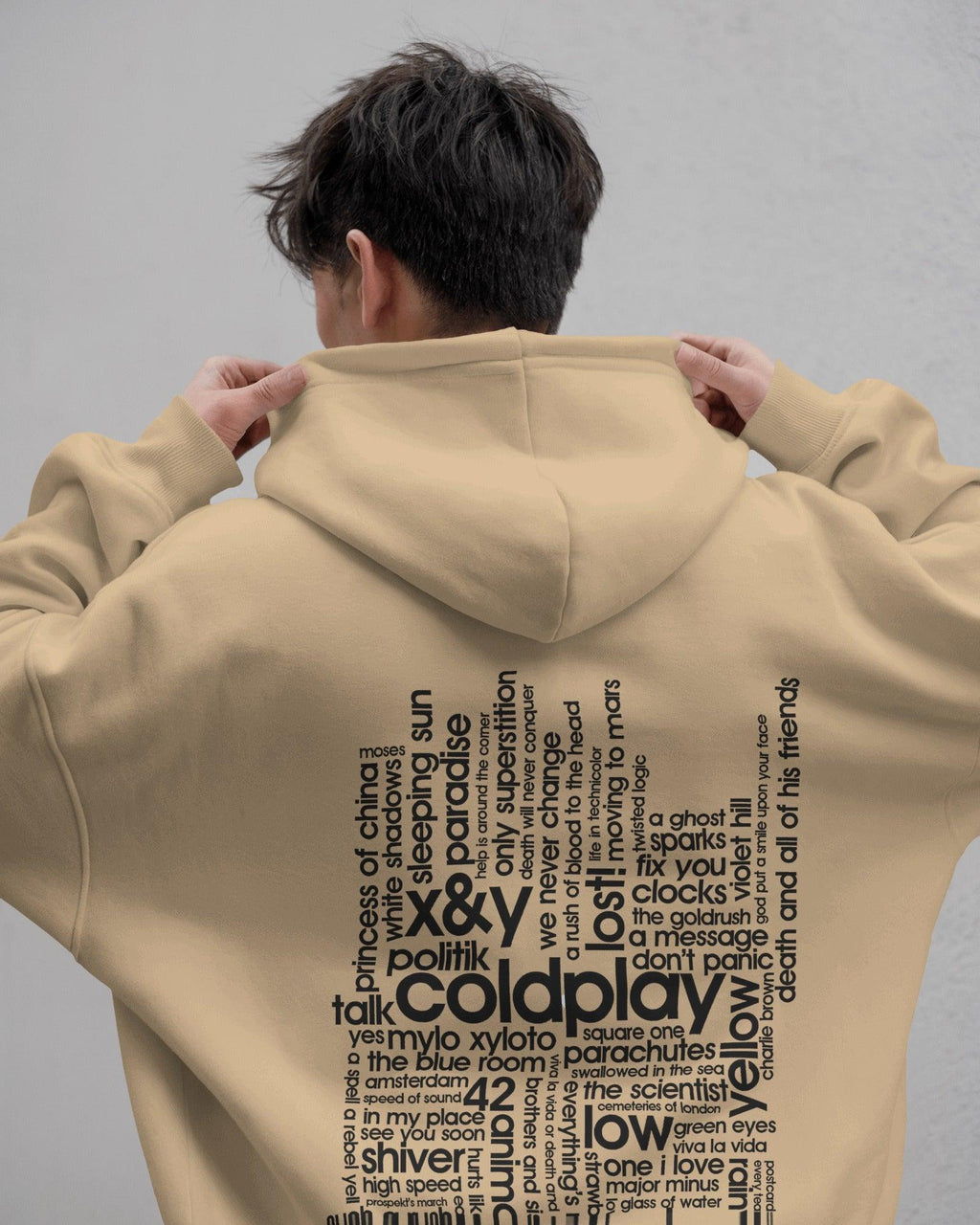 Beige hoodie from Nitorious Atelier featuring a Coldplay-inspired design. Made with 100% premium cotton fleece, this hoodie offers unmatched comfort, warmth, and style for music lovers.