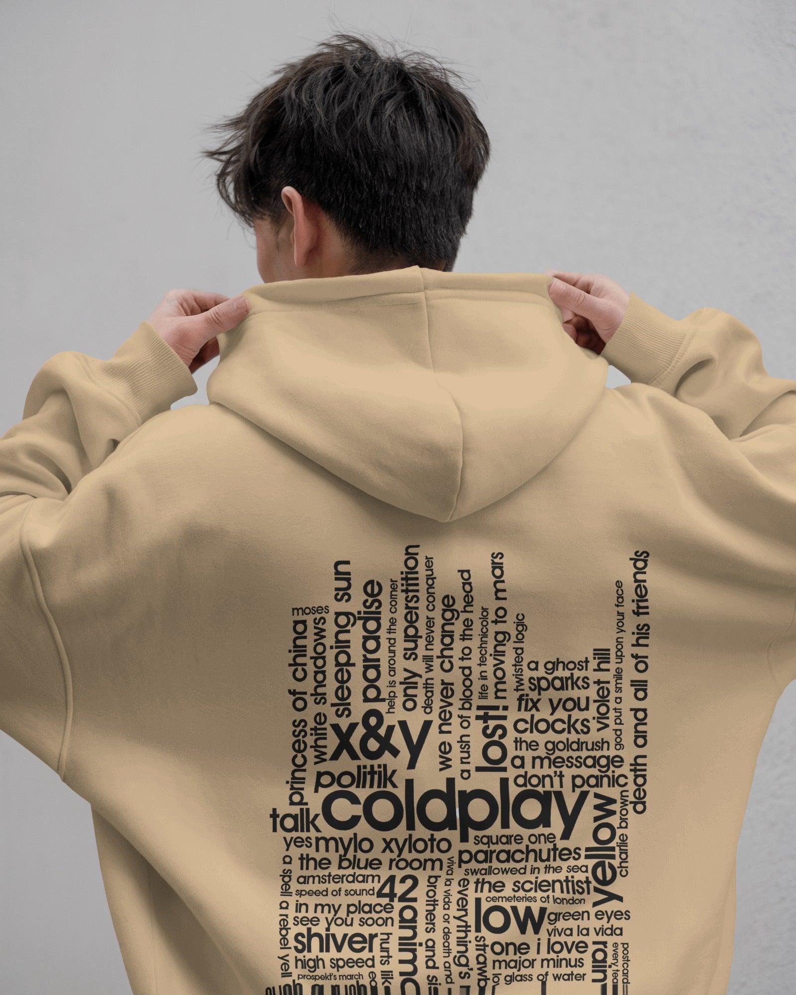 Beige hoodie from Nitorious Atelier featuring a Coldplay-inspired design. Made with 100% premium cotton fleece, this hoodie offers unmatched comfort, warmth, and style for music lovers.