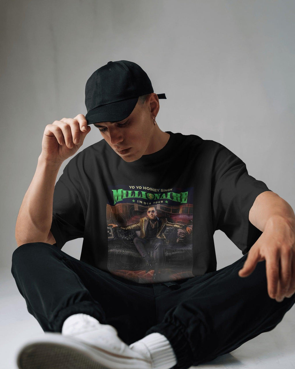 Black oversized t-shirt from Nitorious Atelier featuring the "Honey Singh Million Tour" graphic print. Made from premium cotton, this t-shirt offers a soft feel, durable fabric, and a relaxed fit for ultimate comfort and style.