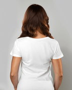 Woman wearing a plain white t-shirt against a gray background