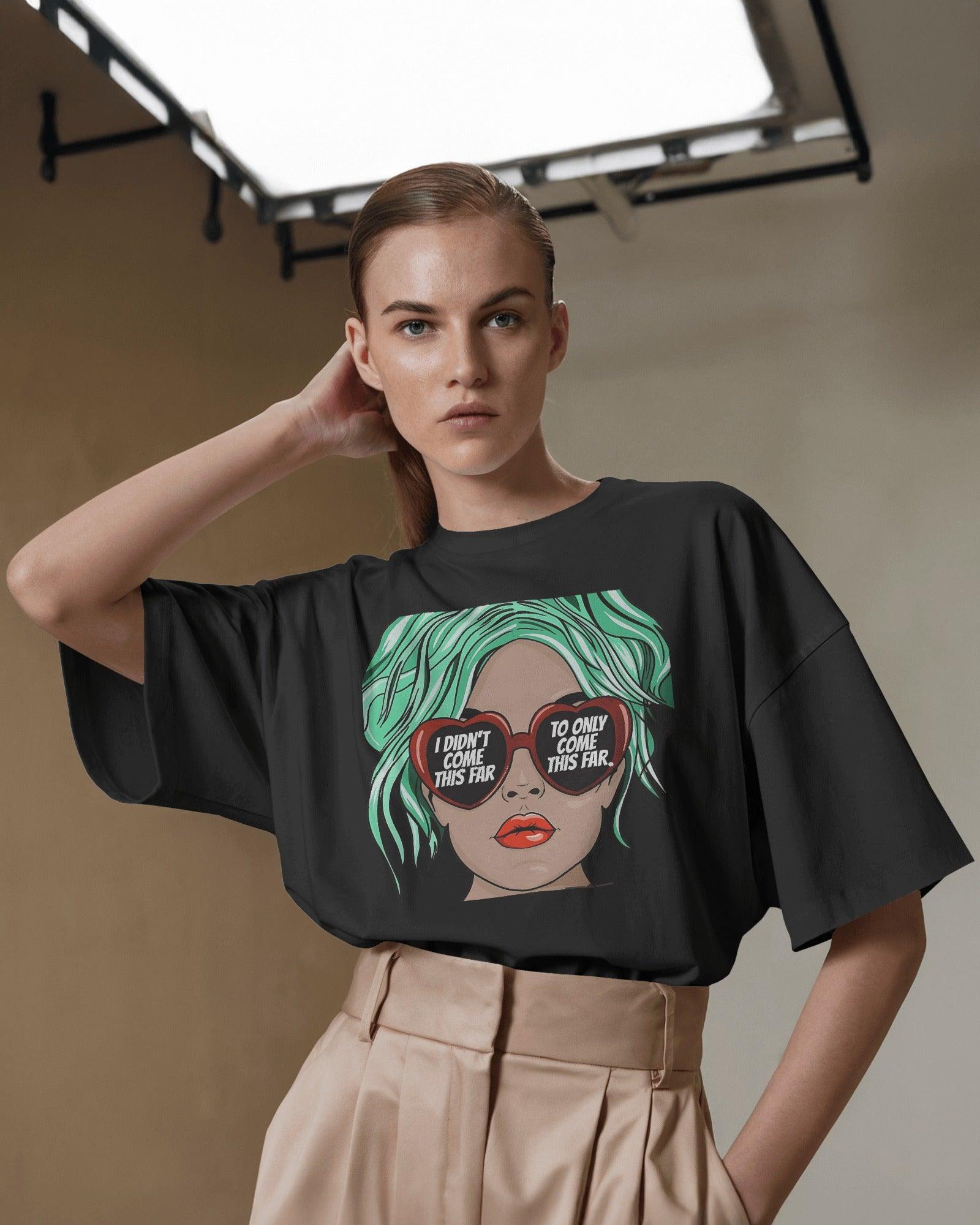 Oversized black t-shirt for women featuring the motivational quote "I Didn’t Come This Far to Only Come This Far" in bold typography. Made from premium cotton, this t-shirt offers a relaxed and comfortable fit. Worn by a confident girl, the statement design adds an empowering touch to casual and streetwear outfits.