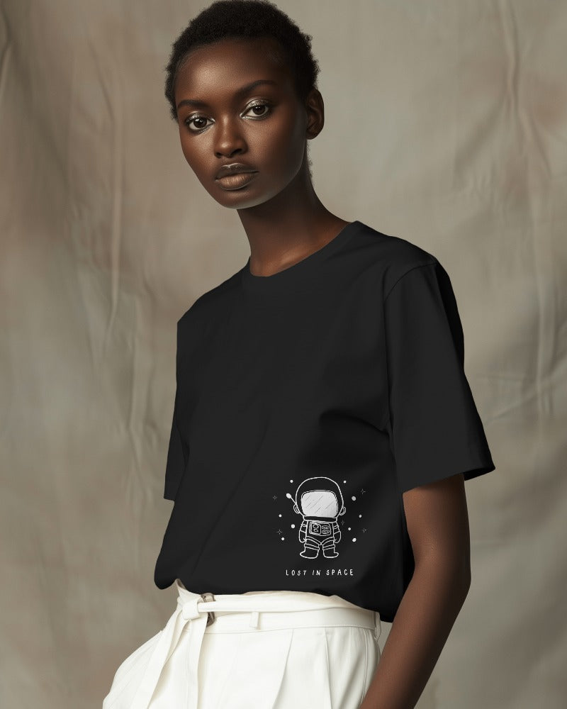 Lost in Space Oversized Black T-Shirt from Nitorious Atelier. Featuring a captivating space-themed graphic, this t-shirt is crafted from premium cotton for a soft, durable, and comfortable fit. Perfect for those who love exploring the cosmos through fashion.