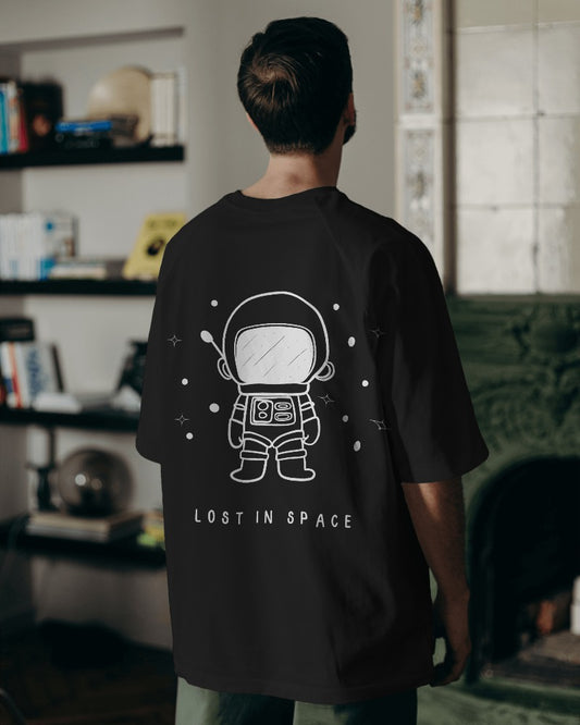 Lost in Space Oversized Black T-Shirt from Nitorious Atelier. Featuring a captivating space-themed graphic, this t-shirt is crafted from premium cotton for a soft, durable, and comfortable fit. Perfect for those who love exploring the cosmos through fashion.