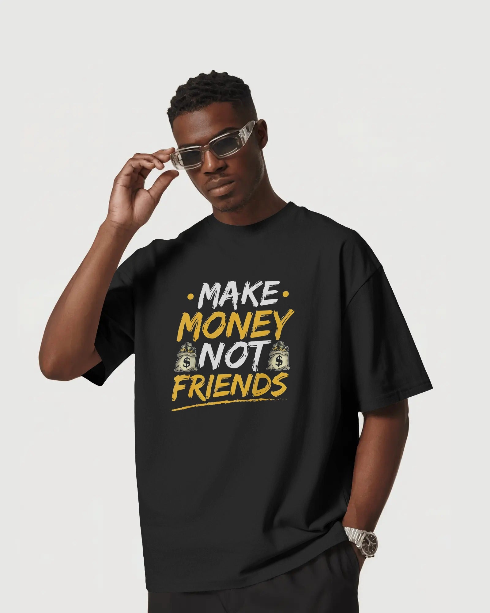Person wearing a Nitorious Atelier black t-shirt with 'Make Money Not Friends' text on a plain background