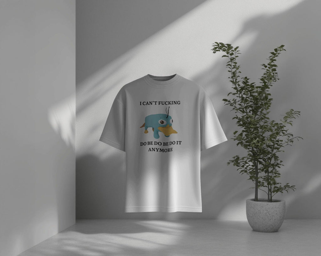 Oversized ‘I Can’t F*ing Do Be Do Be Do Be It Anymore’ t-shirt from Nitorious Atelier featuring Perry the Platypus. A bold, weird, and relatable statement piece made from premium cotton for ultimate comfort and style.