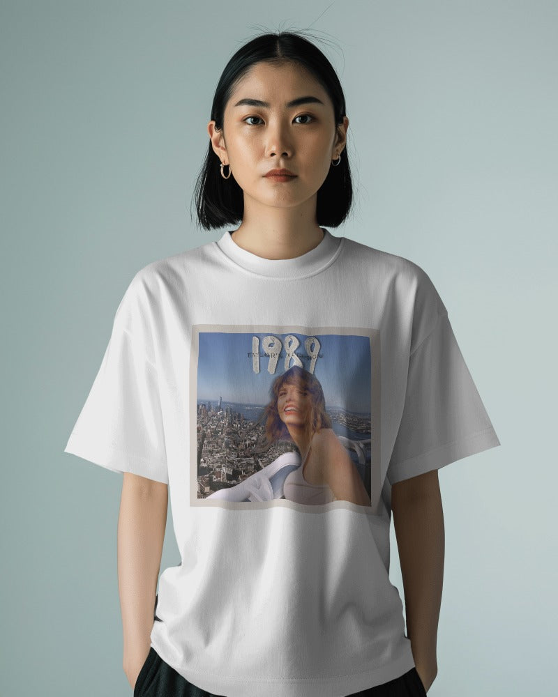 Oversized white t-shirt from Notorious Atelier featuring a bold Taylor Swift graphic. Made from premium cotton, this t-shirt offers a relaxed fit and a stylish tribute to the iconic singer, perfect for fans and casual wear.