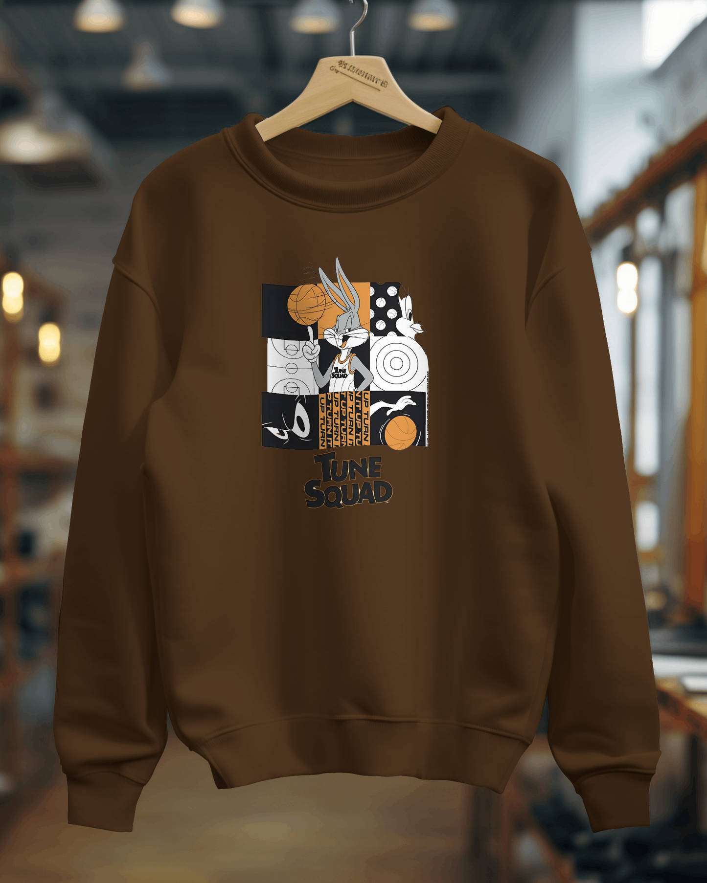 Brown Looney Tunes Sweatshirt from Nitorious Atelier featuring vibrant prints of classic Looney Tunes characters on a warm, earthy background. Made from premium fabric, this sweatshirt offers a relaxed fit and comfortable feel, adding a playful touch to casual outfits.