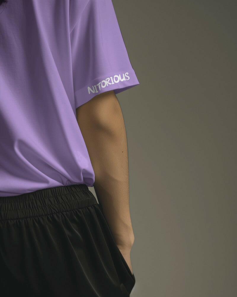 Model wearing a Nitorious Atelier Lavender Oversized Tee, featuring a relaxed fit and premium 220 gsm cotton fabric. The t-shirt showcases a soft lavender color, perfect for a stylish and comfortable look.