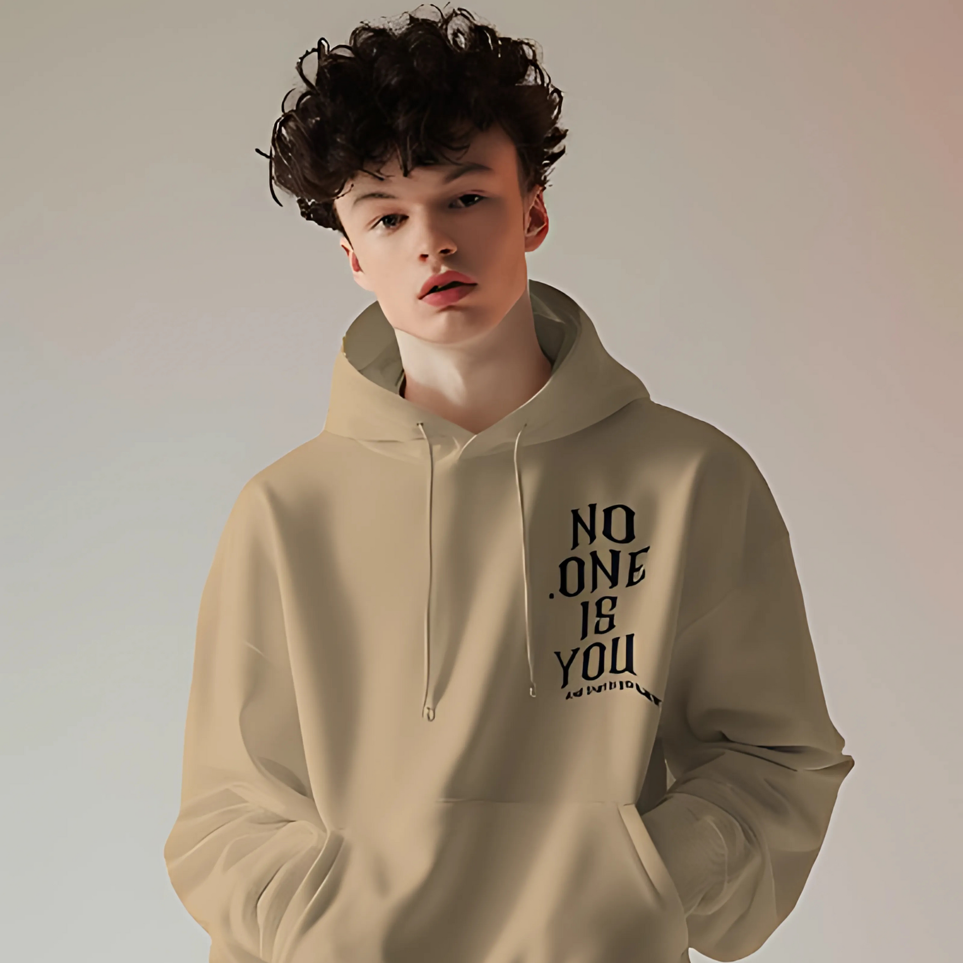 Beige printed hoodie from Nitorious Atelier featuring a sleek, minimalistic graphic design on the front. Crafted from premium cotton fleece, this hoodie provides a cozy fit and a modern, understated look.