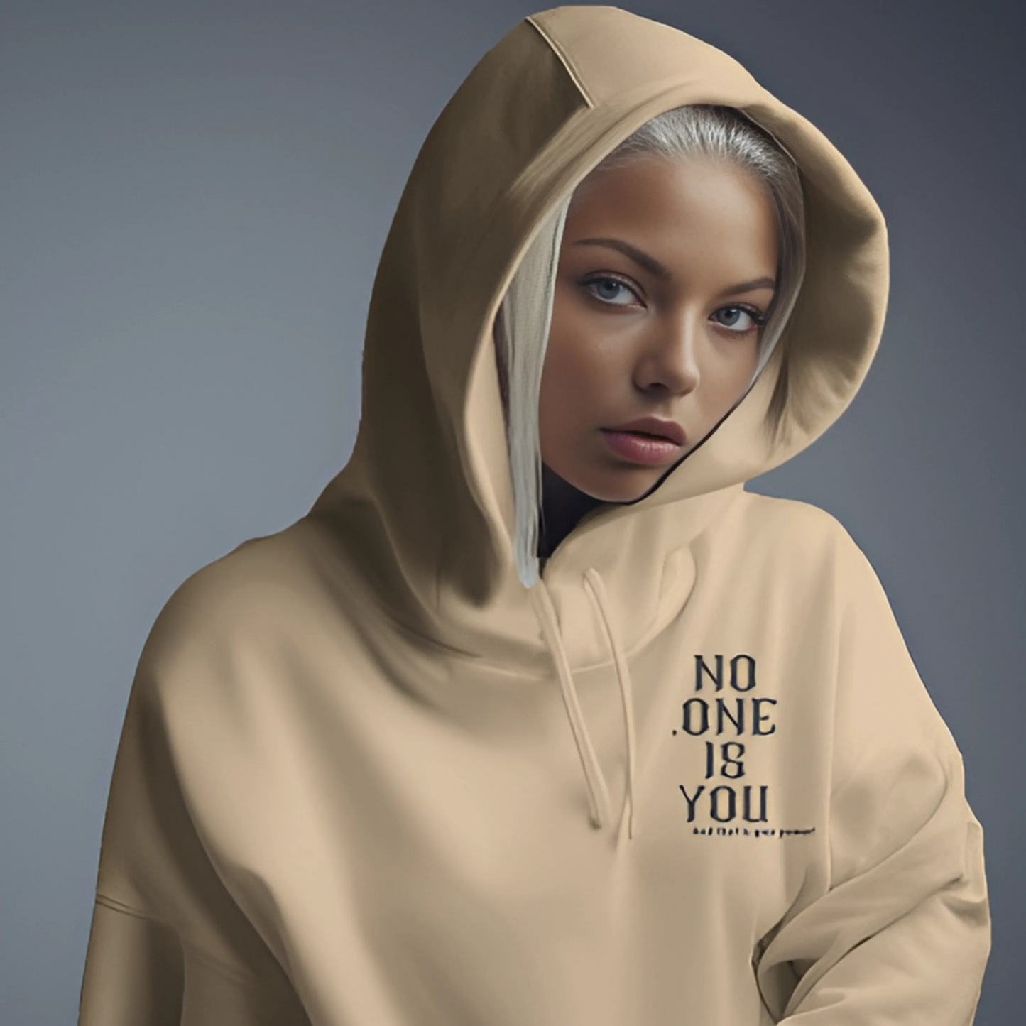 Beige printed hoodie from Nitorious Atelier featuring a sleek, minimalistic graphic design on the front. Crafted from premium cotton fleece, this hoodie provides a cozy fit and a modern, understated look