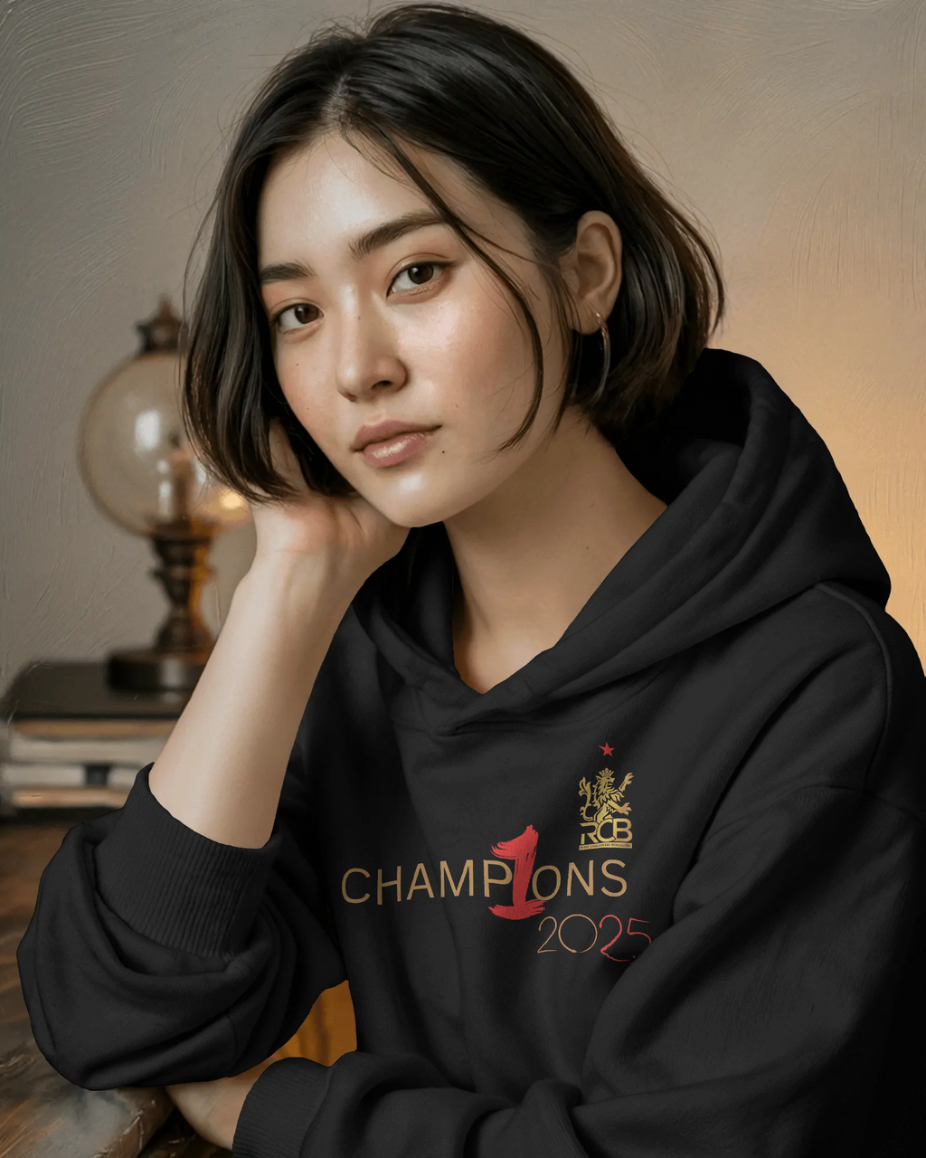 RCB Champions Luxe Hoodie in rich black, celebrating Royal Challengers Bangalore’s iconic victory. Crafted from premium cotton fleece, it features a detailed champion-themed graphic, cosy fit, and a high-quality finish for ultimate comfort and fan pride.