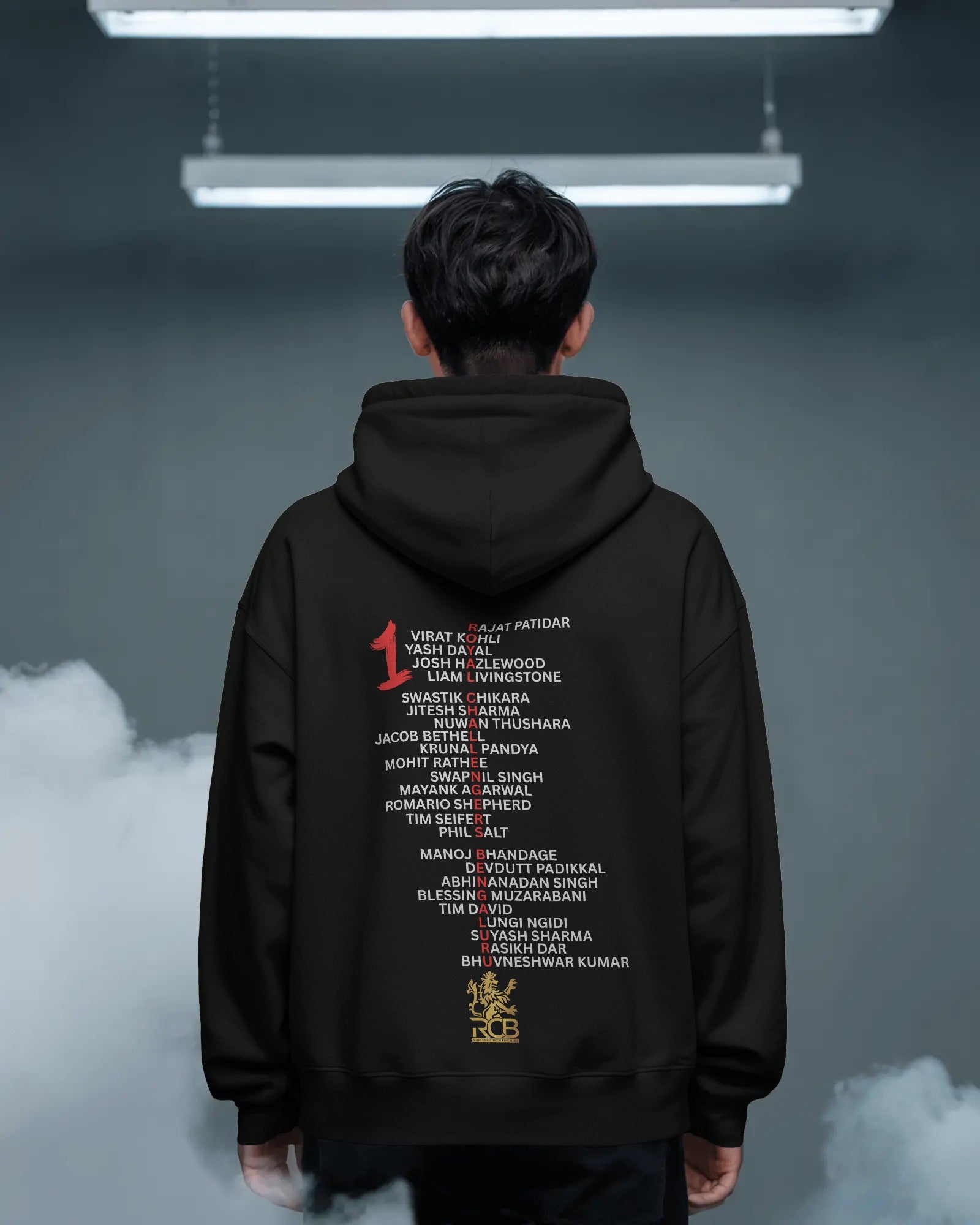 RCB Champions Luxe Hoodie in rich black, celebrating Royal Challengers Bangalore’s iconic victory. Crafted from premium cotton fleece, it features a detailed champion-themed graphic, cosy fit, and a high-quality finish for ultimate comfort and fan pride.