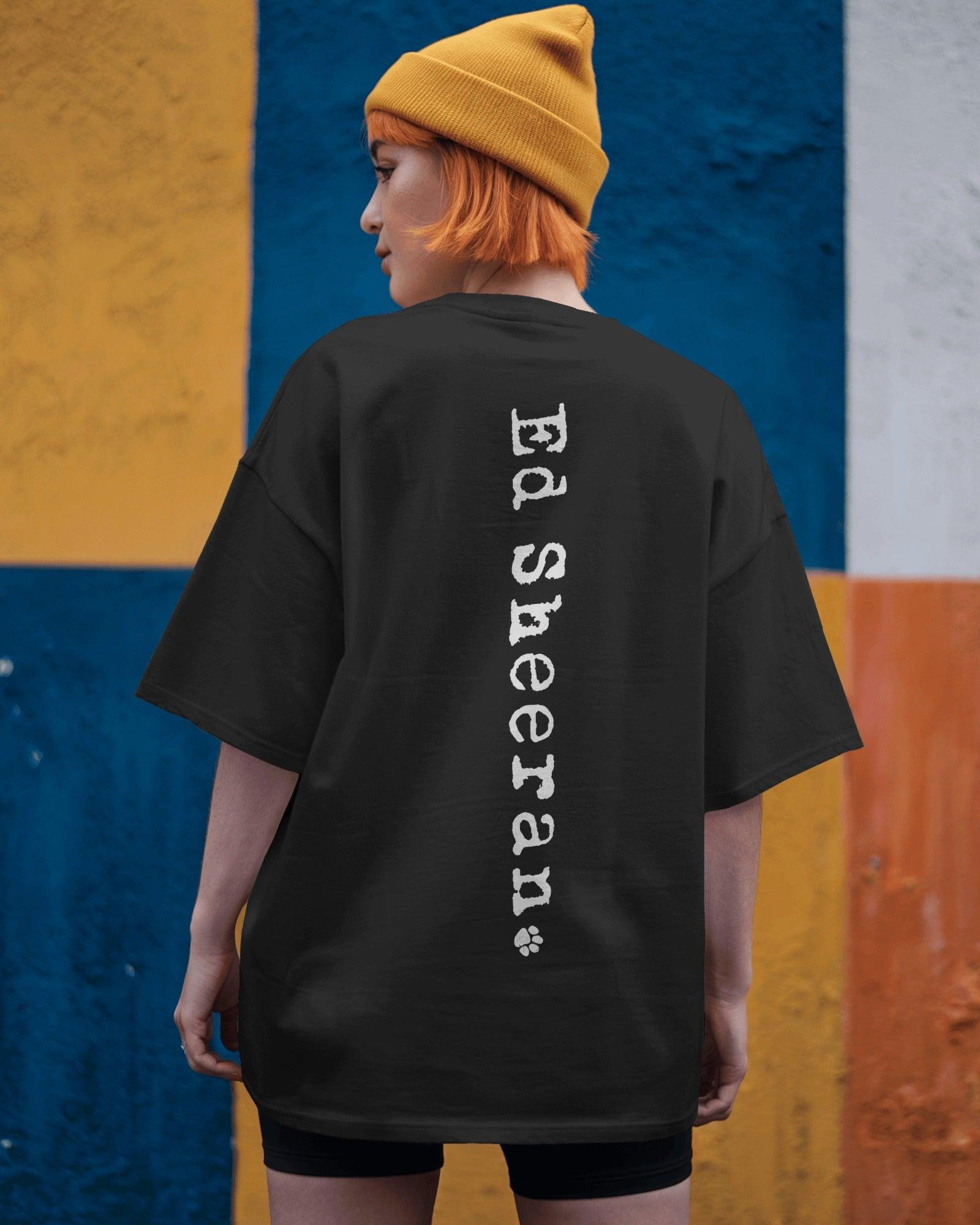 Ed Sheeran Song Black Oversized T-shirt by Nitorious Atelier. This black t-shirt showcases a striking song-inspired graphic, offering a tribute to Ed Sheeran's music. Made from premium cotton, it combines comfort with a trendy oversized fit, ideal for music lovers and casual wear enthusiasts.