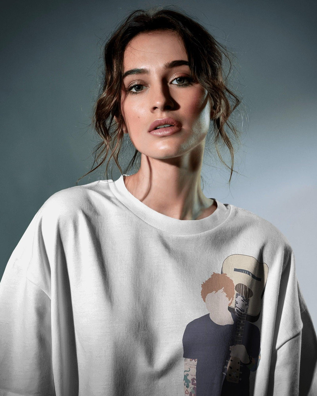 White oversized Ed Sheeran t-shirt from Nitorious Atelier featuring a high-quality graphic print of the iconic singer-songwriter. Made from premium cotton, this t-shirt offers a soft, breathable, and relaxed fit for ultimate comfort and style.