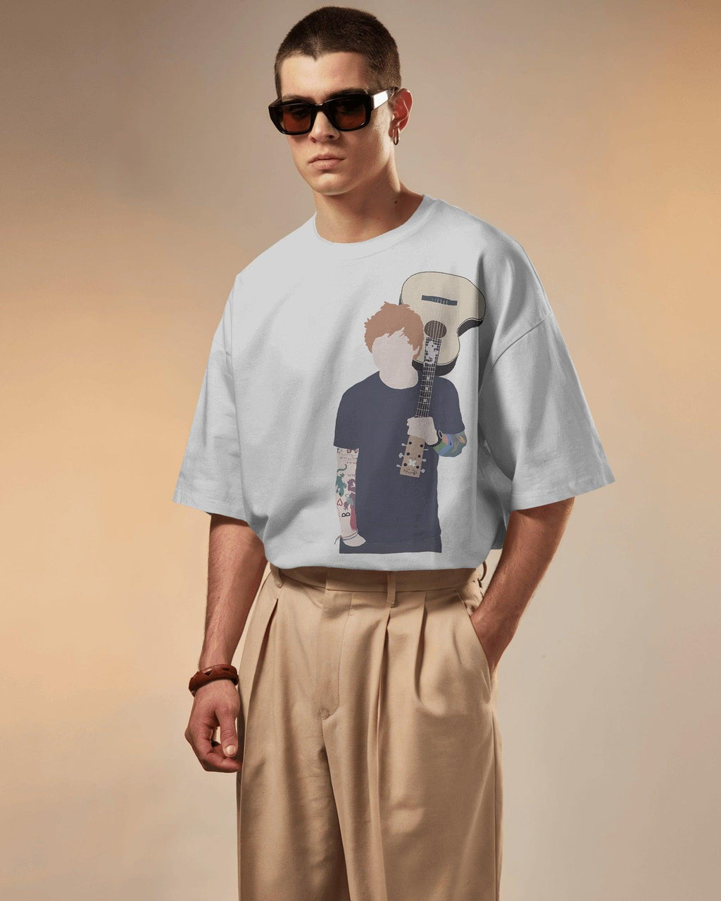 White oversized Ed Sheeran t-shirt from Nitorious Atelier featuring a high-quality graphic print of the iconic singer-songwriter. Made from premium cotton, this t-shirt offers a soft, breathable, and relaxed fit for ultimate comfort and style.