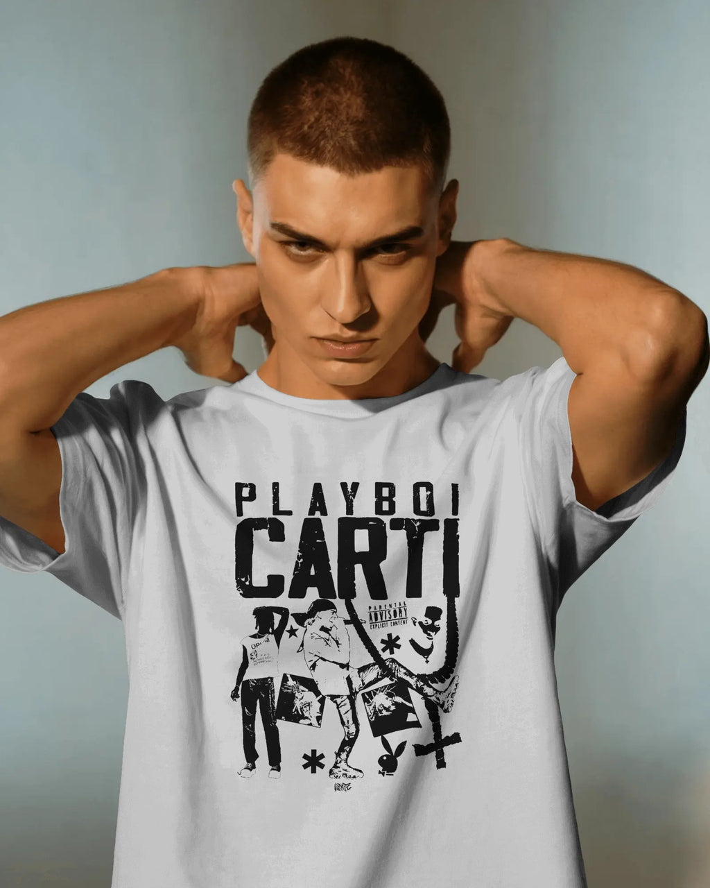 Man wearing a white t-shirt with 'Playboy Carti' graphic design on a plain background